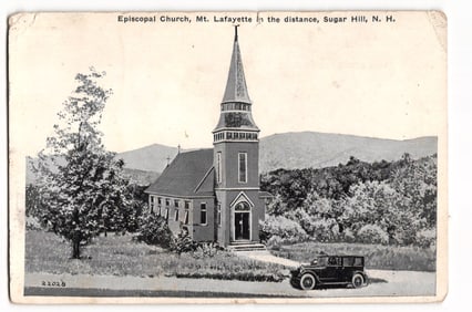 Postcard showing the Episcopal Church at Sugar Hill, NH with Mt. Lafayette and a 1920s automobile.