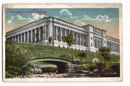 Postcard view of the New Court House in Cleveland, Ohio, with landscaped grounds and a bridge, c.