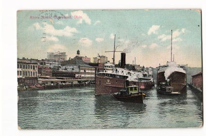 Postcard showing Great Lakes freighters and tugboats docked on the Cuyahoga River, Cleveland, Ohio