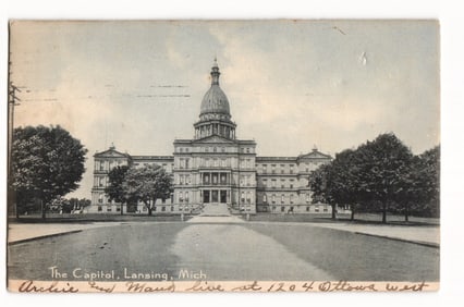 Postcard showing The Capitol building in Lansing, Michigan, with early street and trees c. 1906.