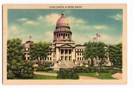 Linen postcard showing the State Capitol building and grounds with flags flying in Boise, Idaho.