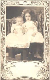 RPPC Real Photo Postcard studio portrait of girl and baby in white lace dresses, circa 1907.