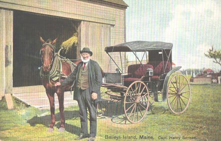 Postcard of Capt. Henry Sennett with his horse and buggy by a large barn in Baileys-Island, Maine.