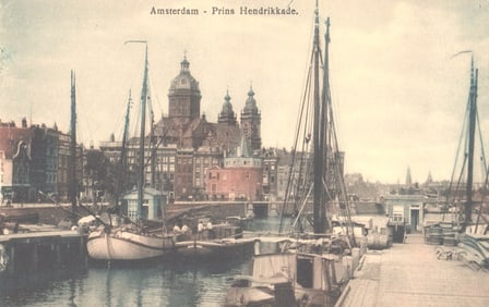 Postcard showing Amsterdam's Prins Hendrikkade harbor with sailboats and the Basilica of St.