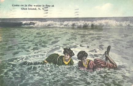 Postcard of two women in early bathing costumes enjoying the surf at Glen Island, New York c. 1912.