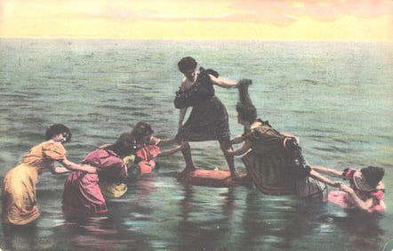 Color postcard of several women in full Edwardian bathing costumes playfully trying to topple a