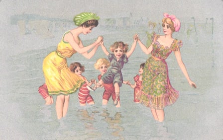 Undivided back postcard with women and children in swimwear enjoying a day at the beach c. 1905.
