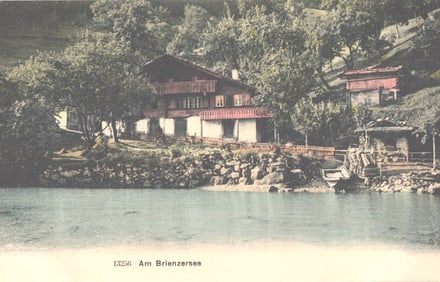 Postcard showing a scenic view of a chalet on the shoreline of Am Brienzersee, Lake Brienz,