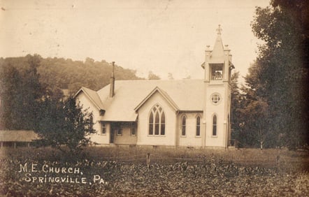 RPPC Real Photo Postcard showing the M. E. Church building and grounds in Springville, Pennsylvania