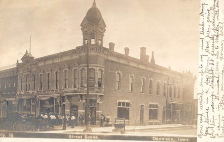 RPPC Real Photo Postcard of a Street Scene in Dennison, Iowa featuring the First National Bank c.