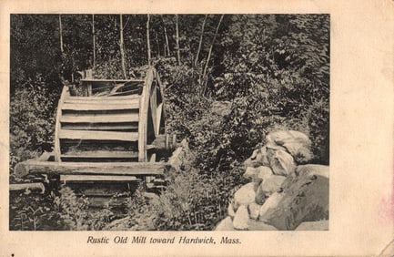 Postcard showing a view of the rustic old wooden water mill surrounded by trees near Hardwick, Mass.