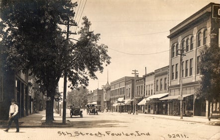 RPPC Real Photo Postcard of 5th Street in Fowler, Indiana showing storefronts and early cars c.