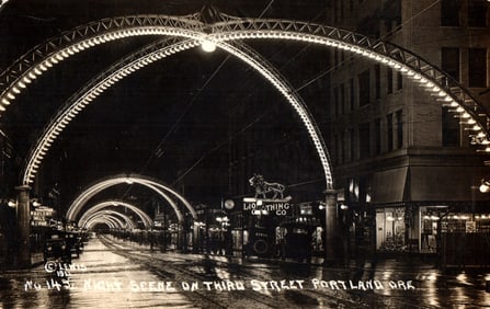 RPPC postcard of a night scene on Third Street, Portland, Oregon with its illuminated arches circa