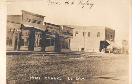 RPPC Real Photo Postcard of Camp Crook, South Dakota street view with J.F. Divine store, c. 1910.