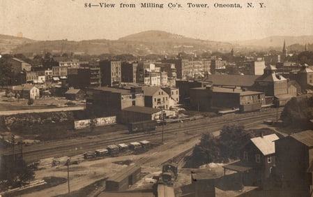 Postcard showing the cityscape view from the Milling Co's. Tower in Oneonta, New York, c. 1910s.