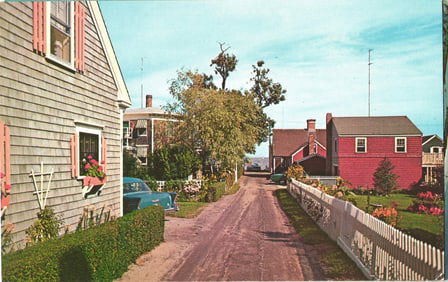 Postcard of a residential lane with a classic car and clapboard homes on Historic Long Island, NY