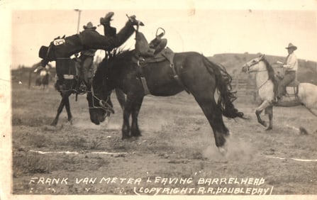 RPPC Real Photo postcard of Rodeo Cowboy Frank Van Meter on bucking bronco Barrelhead, North Platte,