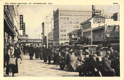 Postcard of St. Petersburg, Florida's famous Green Benches showing a bustling 1930s downtown scene.