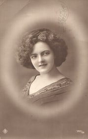 RPPC Real Photo Postcard of an Edwardian woman with a bouffant hairstyle. German studio portrait