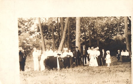 RPPC Real Photo Postcard of a large group singing from songbooks around an organ at a camp meeting.