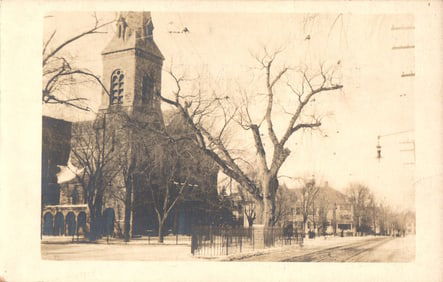 RPPC Real Photo Postcard of a stone church and large tree on a quiet street, c. 1900s undivided