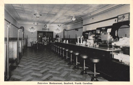 Postcard of Sanford, North Carolina's Fairview Restaurant showing the interior counter and booths c.