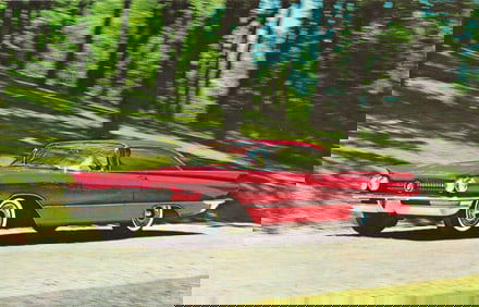 Postcard showing a 1960 Turbine Drive Buick Invicta 2-Door Hardtop in Magic-Mirror Titian Red.