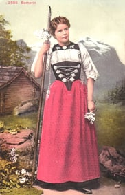 Postcard of a Swiss woman in traditional Bernerin folk costume holding a staff with edelweiss