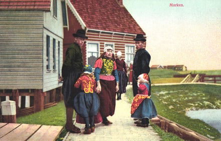 Postcard depicting a Dutch family in colorful traditional folk dress on a path in Marken,
