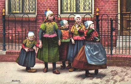 Photochromie postcard showing five young girls wearing traditional Dutch folk costumes in Marken,