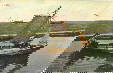 Postcard showing two people in traditional costume on a small sailboat in the village of Marken,