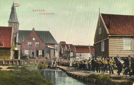 Postcard of Marken, Netherlands showing the Koninginnefeest (Queen's Day) celebration and parade.