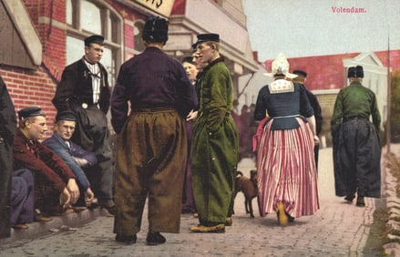 Postcard showing villagers in traditional Dutch clothing on a street scene in Volendam, Netherlands.