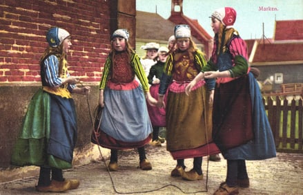 Photochromie postcard of girls in colorful Dutch folk costumes playing jump rope in Marken, c. 1910s