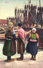 Photochrom postcard of three children in colorful traditional folk dress on a dock in Marken,