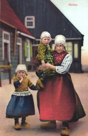 Postcard of a Dutch woman and two children in traditional folk costume, Marken, Netherlands c.1910