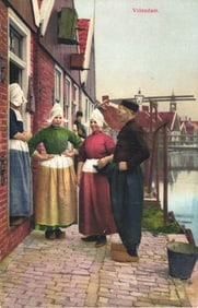 Photochromie postcard of people in traditional Dutch costumes in the fishing village of Volendam.