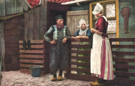 Postcard showing a man and two women in traditional Dutch costumes in Volendam, Netherlands c.