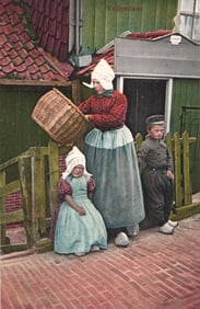 Color postcard showing a Dutch family in traditional clothing in the fishing village of Volendam, c.