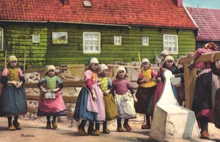 Photochrome postcard showing young girls in traditional Dutch folk costumes and clogs in Marken,