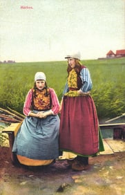 Photochrome postcard of two young women in traditional Dutch folk costumes in a rural Marken