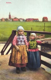 Photochrome postcard showing two young girls in traditional Dutch folk costumes in Marken, Holland.