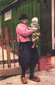 Photochromie postcard of a man in traditional Marken Dutch costume holding a child, Netherlands