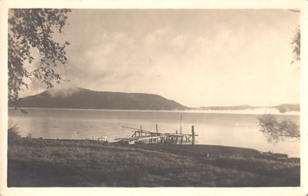 RPPC Real Photo Postcard by Slotes Studio showing a placid lake and pier, Cooperstown, NY 1908.