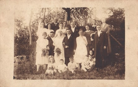 RPPC Real Photo Postcard of a large wedding group with bride, groom, and children outdoors c.1920s.