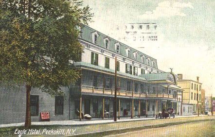 Postcard showing the Eagle Hotel in Peekskill, New York. Early street view with horse and carriage.