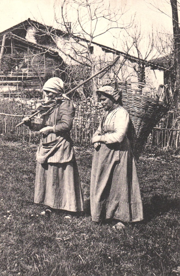 Postcard by Brunner & C., Como & Zürich, showing two peasant women in folk dress with farm tools.: Please view photos for further description and condition considerations. Please know the scans may be darker or lighter than the actual item's true appearance. ACME Auctions offers FREE DOMESTIC SHIPP