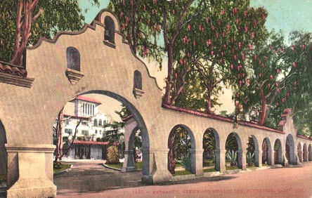 Postcard of the entrance archway and wall at the Glenwood Mission Inn, Riverside, California