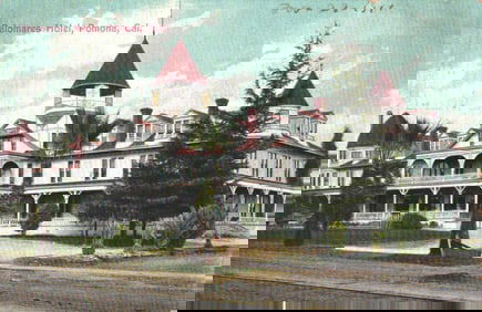 Postcard of the Palomares Hotel, a grand building with distinctive red-roofed turrets in Pomona,