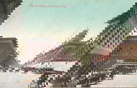 Postcard of Second Street in Pomona, California, a bustling scene with early autos and a trolley